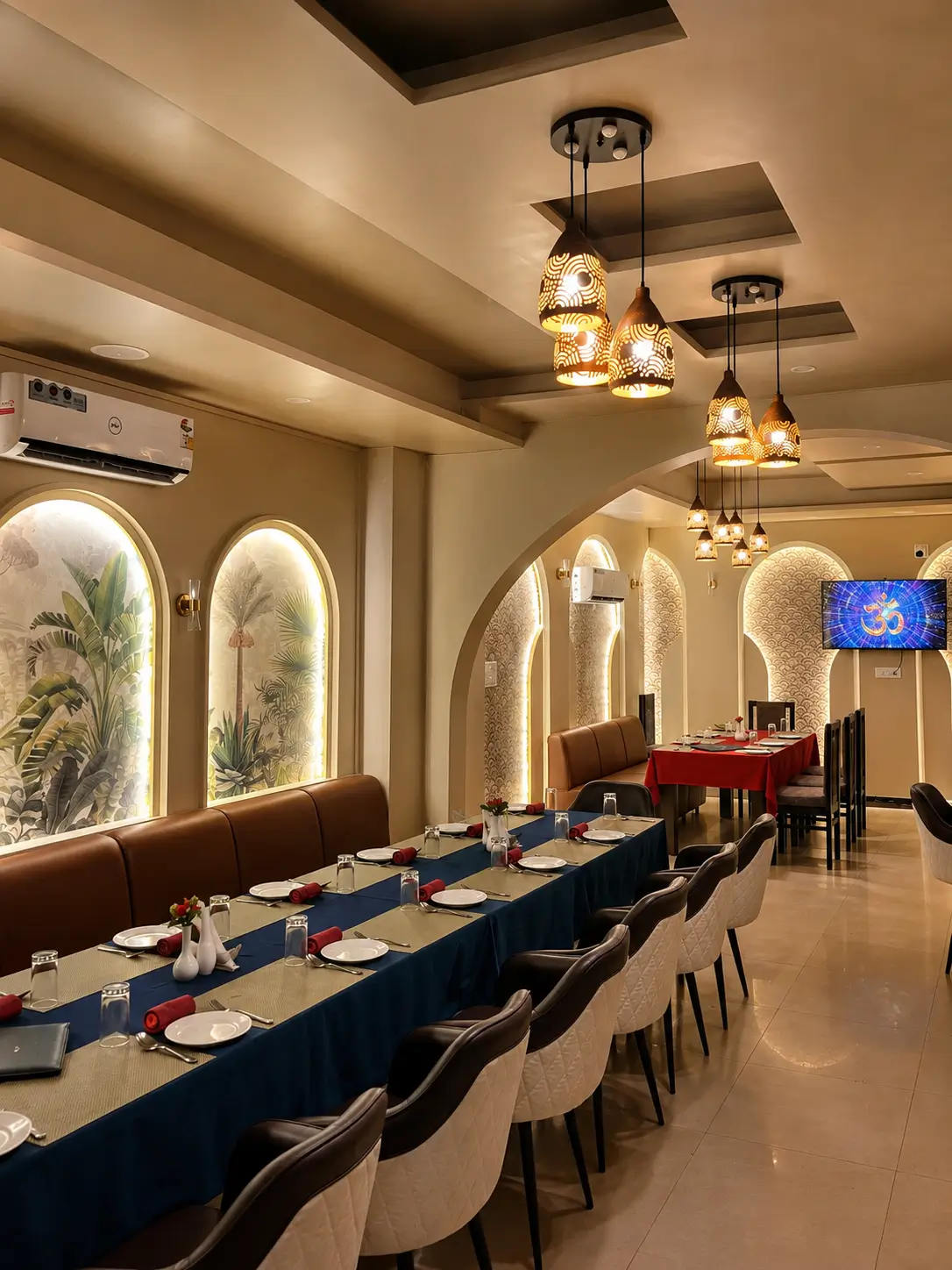 Restaurant dining hall at Hotel H Plus with table setup and ambient hanging lights